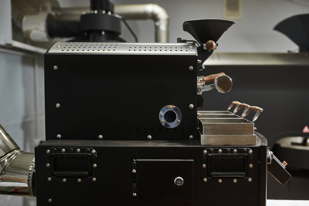 Equipment and technologies for coffee processing. A modern professional coffee roasting machine. Close-up. - Photo, Image