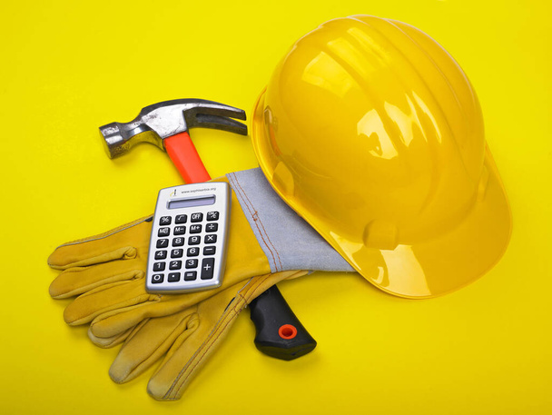 Ready fgor building site - HardHat Hammer Gloves Calculator - Foto, Imagen