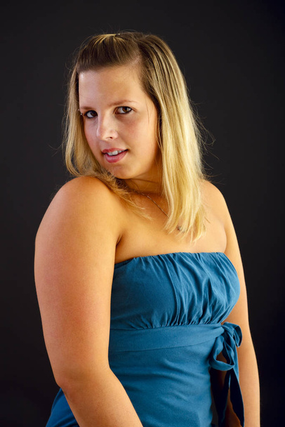 Young blond woman on black background, studio shot. Adobe RGB - Valokuva, kuva