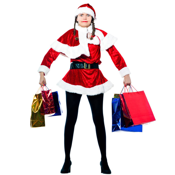 one strong woman dressed as santa claus carrying christmas bags  on studio isolated white background - Foto, Imagem