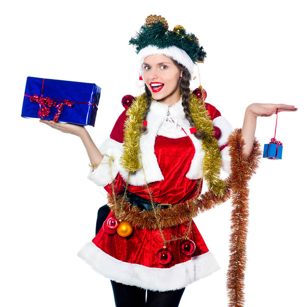 one woman dressed as santa claus holding presents gifts as christmas tree on studio isolated white background - Photo, Image