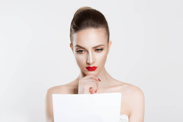 Woman beauty reading looking attentively a contract, bank statement, tax papers, newspaper documents. Actress miss bride learning her lines text vow isolated white background wall - Fotó, kép