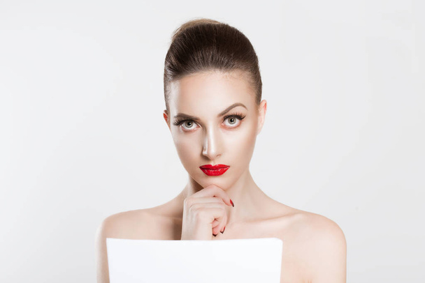 Skeptical about new contract. Actress bride beauty woman looking at you camera thinking analyzing holding paper document prenuptial marital contract tax papers newspaper isolated white background wall - Photo, image