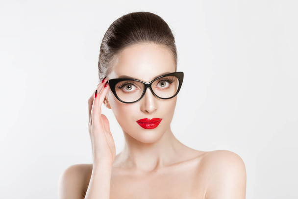 Vision. Closeup attractive fashion sexy girl wearing eye glasses woman holding her pair of glasses isolated white light grey background wall - 写真・画像