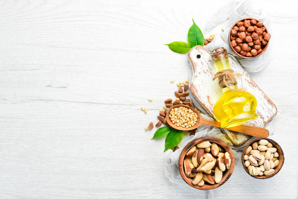 Cold pressed nut oil. Assortment of nuts. free space for your text. Top view. - Photo, image