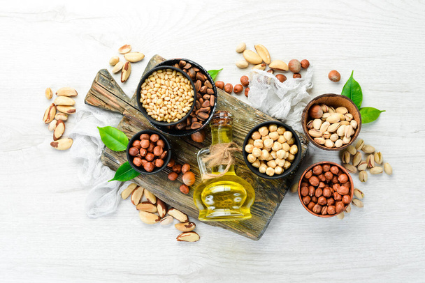 Cold pressed nut oil. Assortment of nuts. free space for your text. Top view. - Фото, зображення