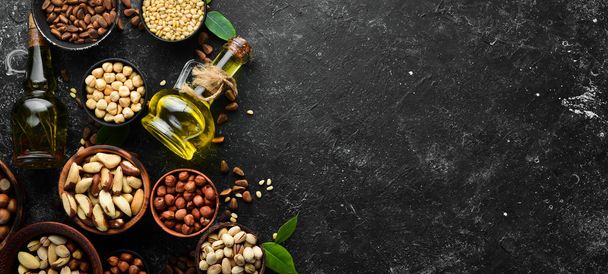 Cold pressed nut oil. Assortment of nuts. free space for your text. Top view. - Φωτογραφία, εικόνα
