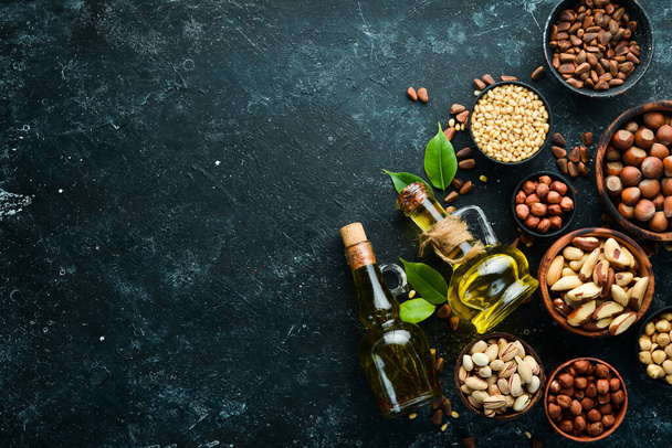 Cold pressed nut oil. Assortment of nuts. free space for your text. Top view. - Foto, immagini