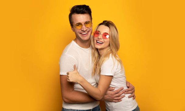 happy couple with thumb up  on studio background  - Foto, afbeelding
