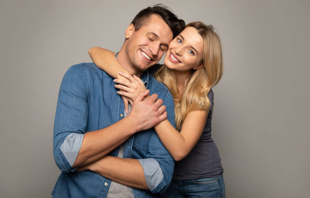 happy couple  embracing on studio background  - Foto, Imagem