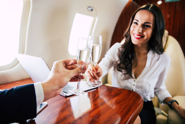 business couple on the plane toasting  - Foto, Imagen