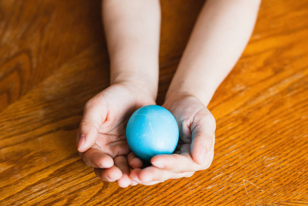 Easter egg in hand, painted eggs, religious holiday, rabbit and find the egg - Fotografie, Obrázek