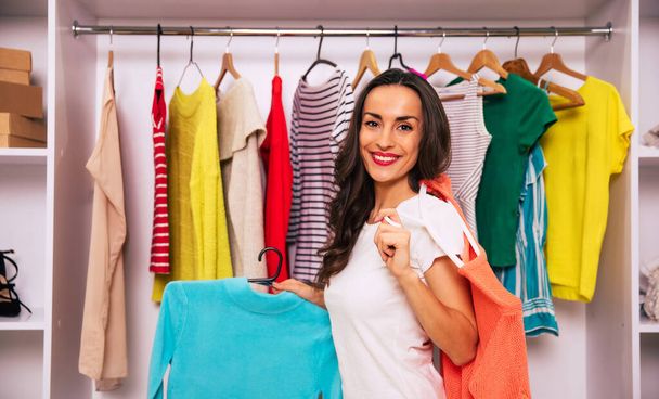 young woman choosing clothes in wardrobe  - Photo, Image