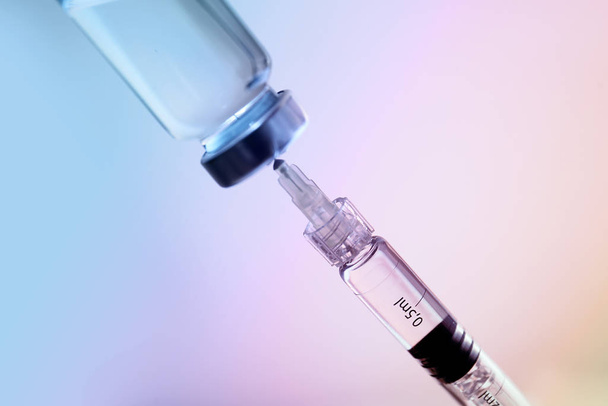 Syringe with filler for cosmetology and ampule on light background, closeup - Photo, Image