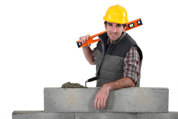 construction worker with a hammer and a trowel - Фото, изображение