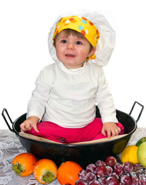 Baby cook with vegetables in studio  - Фото, зображення