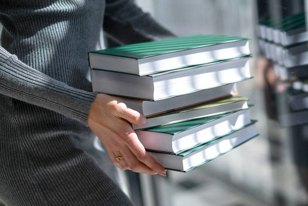 several books in hands girl in sunlight - Φωτογραφία, εικόνα