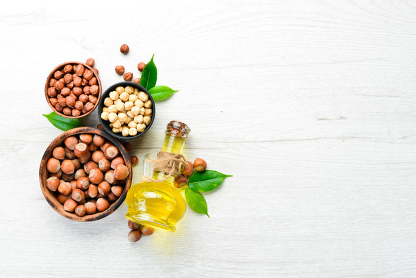 Hazelnut oil and fresh nuts. Top view. Free space for your text. - Zdjęcie, obraz