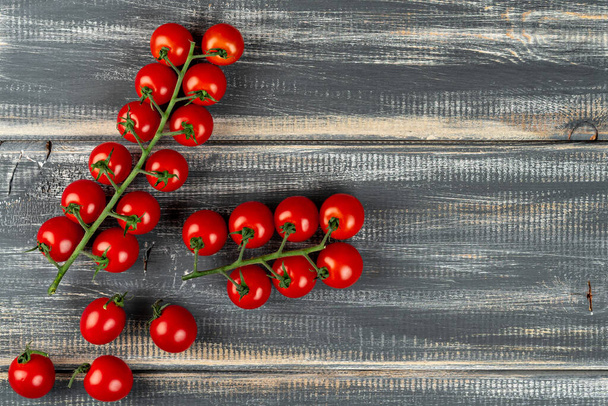 branch cherry tomatoes on black table - Foto, Bild