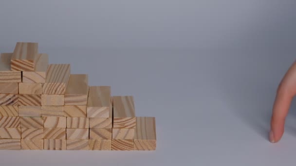 Stacked cubes and female hand imitating walking upstairs against white background. Concept of progress. Closeup Slow motion. - Filmagem, Vídeo
