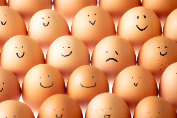 An egg displeased in plenty smiling eggs - Photo, Image