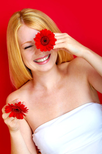 portrait of a young beautiful blonde girl with flower - Zdjęcie, obraz