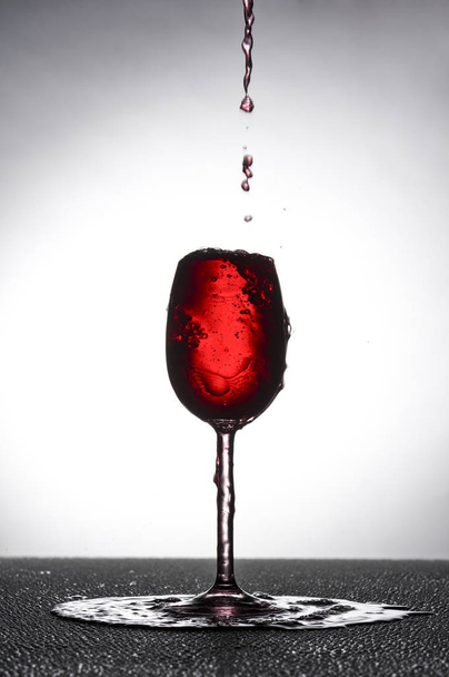 red wine glass in overflowed\n\n                   \n - Foto, immagini