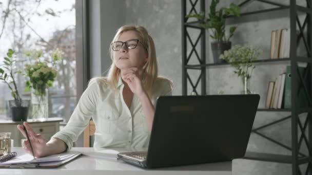 attractive blonde businesswoman working at laptop use app online banking, young woman working remotely at computer rejoices at success in business, online service - Materiał filmowy, wideo