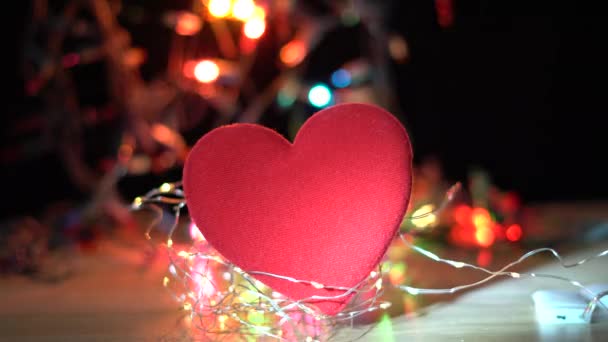 red heart on a wooden deck with light bokeh background, - Footage, Video