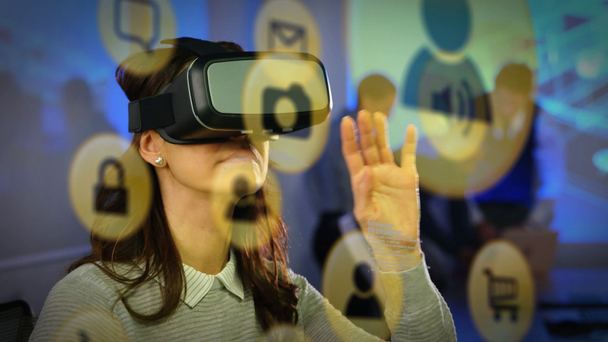 Animation of yellow network connection and data sharing icons with a Caucasian woman sitting in an office using a VR headset in the background - Filmagem, Vídeo