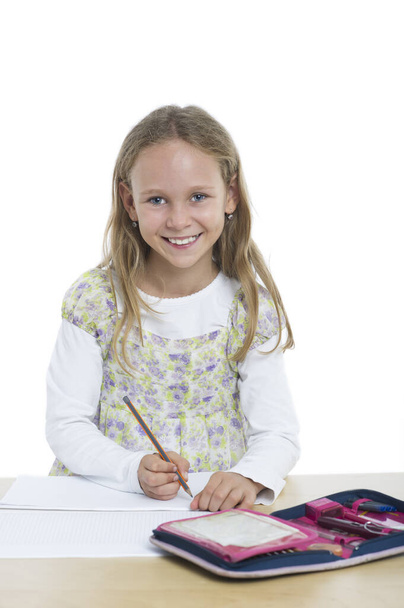 portrait of a cute schoolgirl with a pencil - Fotó, kép