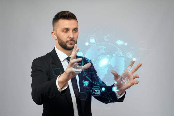 Businessman holding virtual 3D projection in arms. - Photo, image