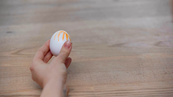 cropped view of woman painting cooked easter egg  - Footage, Video