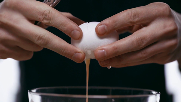 Slow-motion of man breaking egg with knife - Felvétel, videó