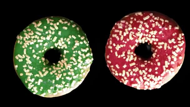 Punainen ja vihreä donitsi kuorrutuksella mustalla pohjalla
 - Materiaali, video