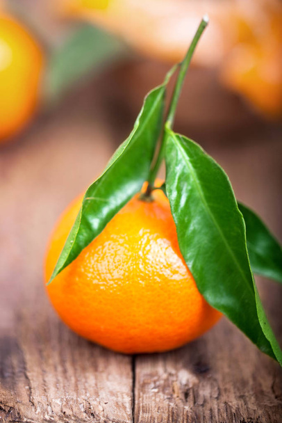 fruity orange tangerine with green leaves against natural background - Photo, Image