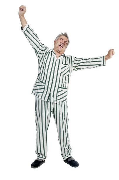 Senior man in pajamas isolated in white - Фото, изображение