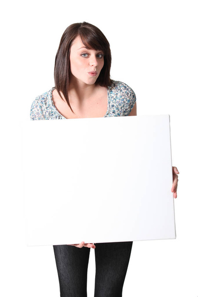 Casual brunette posing with blank board - Foto, Imagen