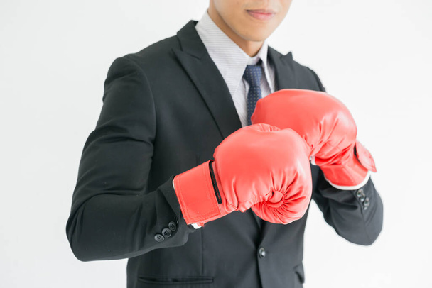 A tough guy businessman is wearing boxing gloves. Abstract concept for competition, sales, marketing, job, or a business career.Close up.businessman in Boxing gloves.concept of competitiveness. - Foto, Imagem