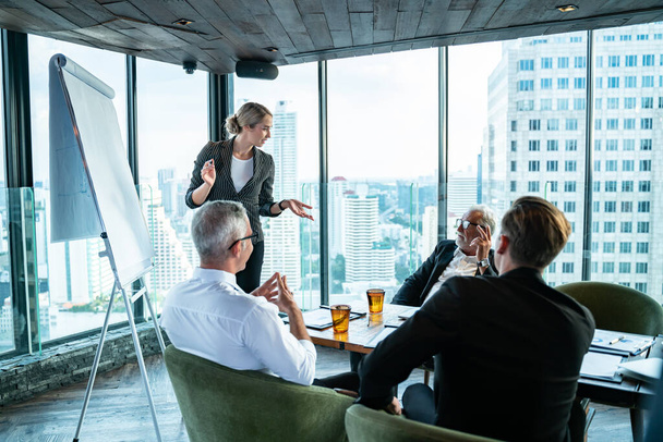 Meeting and discussion concept.business people communicating in office.Mature businessman discuss information with a colleague in a modern business lounge high up in an office tower. - Photo, Image