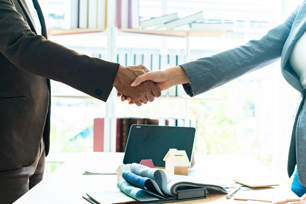 Real estate broker and customer shaking hands after signing a contract, home loan and insurance concept. - Photo, Image