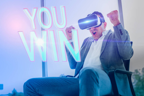 Young businessmen wearing VR glasses play games at work time.businessman wins the VR game. - Foto, Imagem