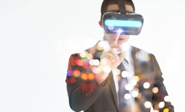 Young man with glasses of virtual reality. Future technology concept.Smartphone using with VR goggles headset. Horizontal,flares effect, blurred background. - Foto, Imagen