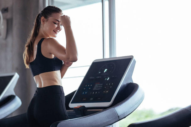 Healthy People running on machine treadmill at fitness gym, Work out concept.Picture of people doing cardio training on treadmill in gym. - Фото, зображення