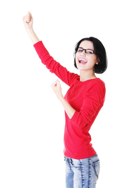 Excited young woman with fists up - 写真・画像