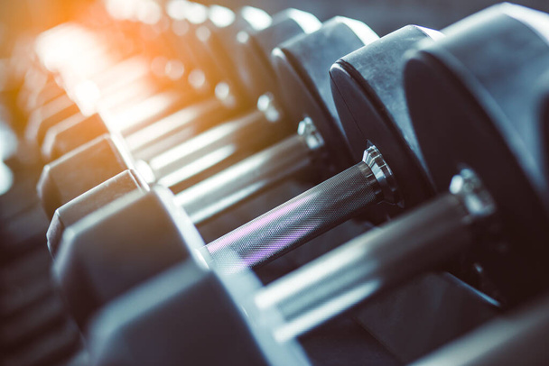 Blur Equipment And Machines At The Empty Modern Gym Room. Fitness Center. Toned image. - 写真・画像