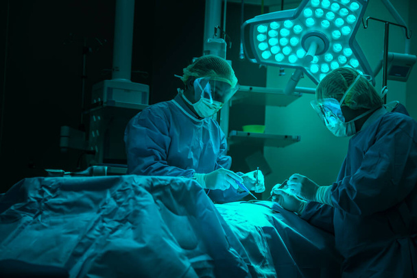 Doctor operation in operation room at hospital concept for insurance advertising.Medical Team Performing Surgical Operation in Modern Operating Room - Foto, Bild