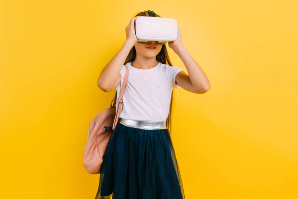 Little girl in school uniform with virtual reality glasses - Fotoğraf, Görsel