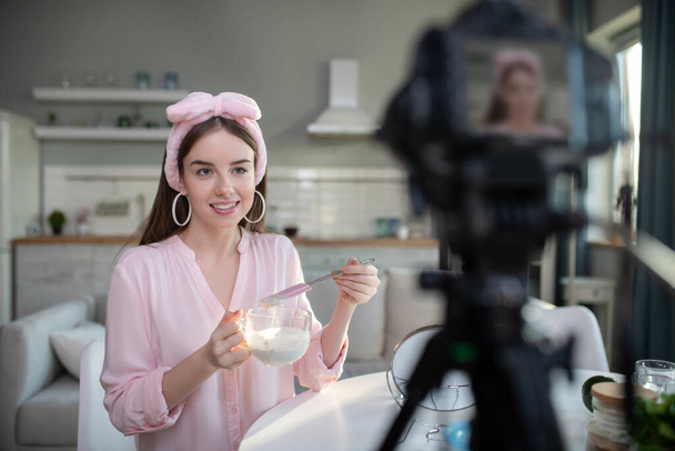 Young pretty girl in a pink headband giving tips on skin care - Foto, Imagem
