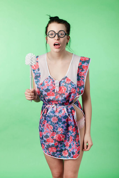 young woman in a dress with a toothbrush on a blue background - Photo, Image